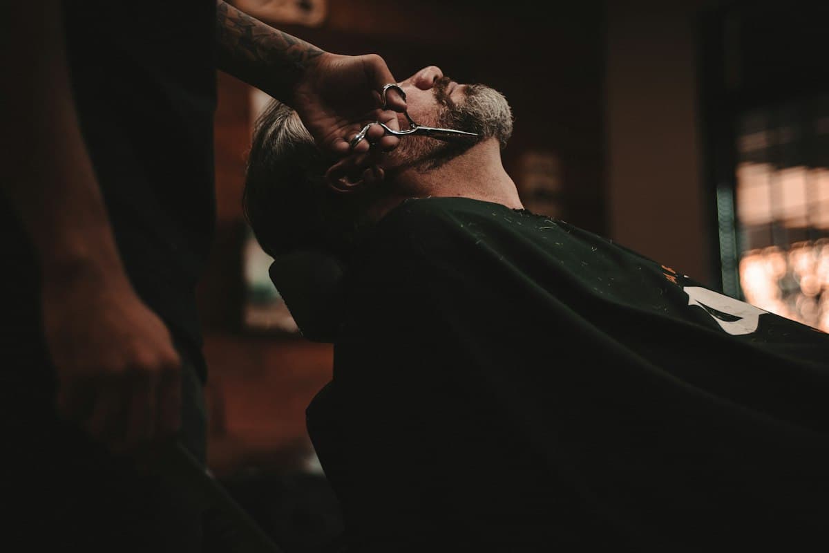 A barber trimming a customer’s beard (representative image)
