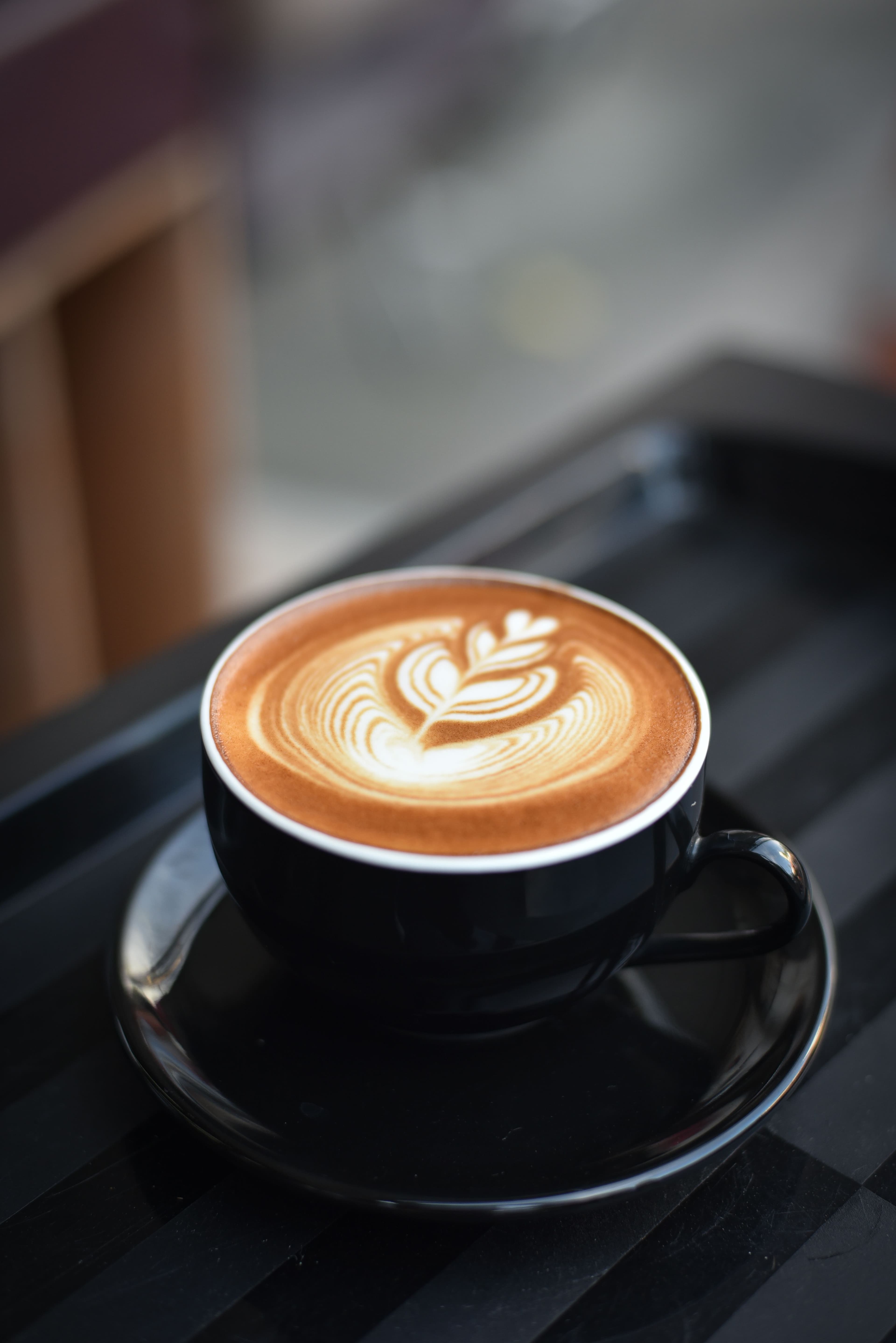 A flat white coffee and pastry on a cafe table, representative image