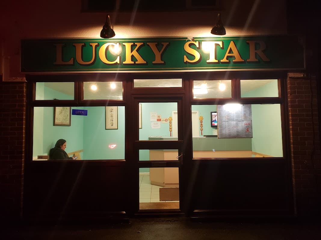 Lucky Star Chinese takeaway shopfront on Hambledon Road, Denmead, at night