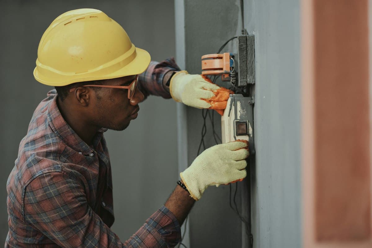 An electrician testing a wall socket (representative image)