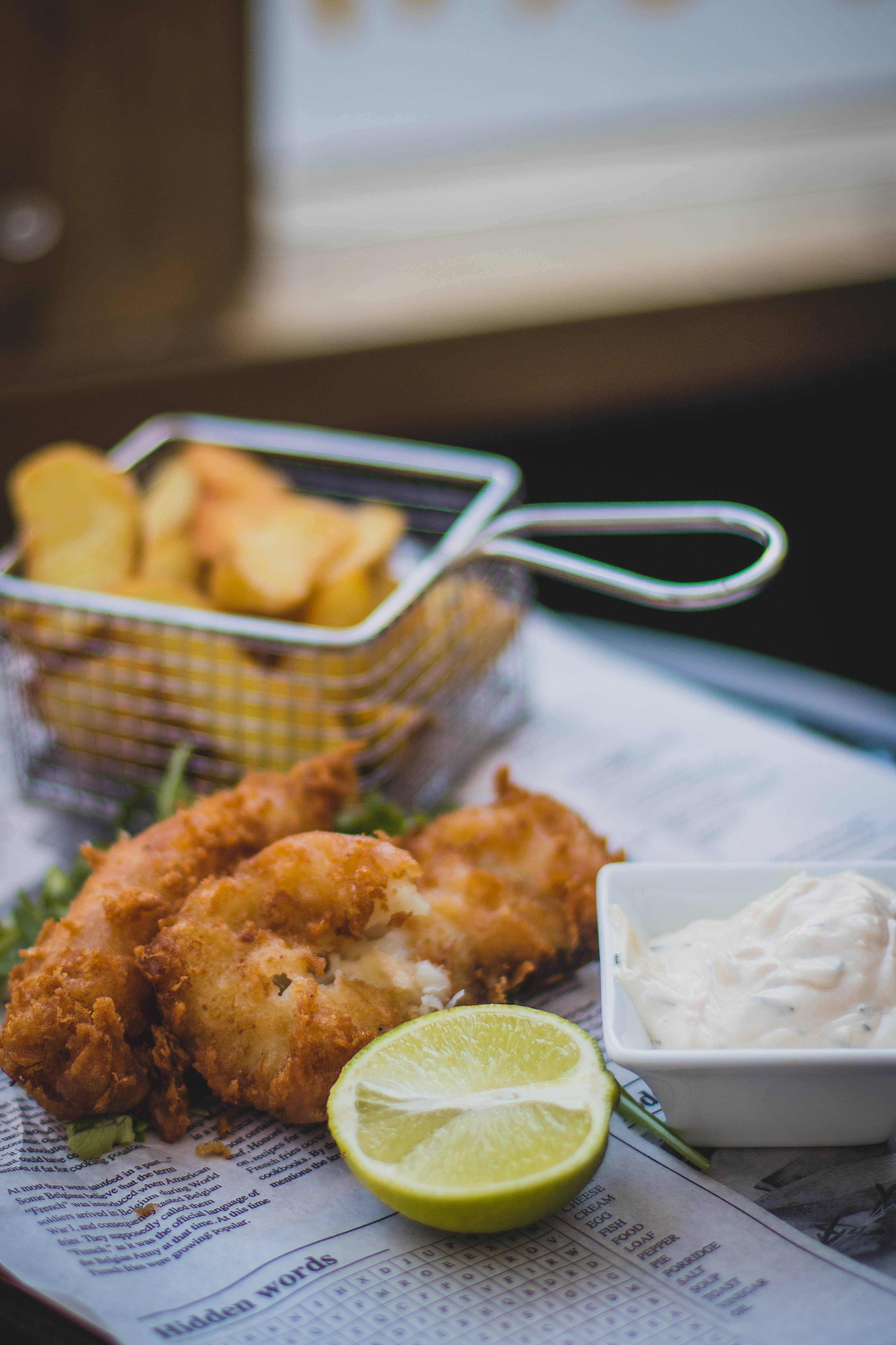 Fish and chips wrapped in paper, representative image