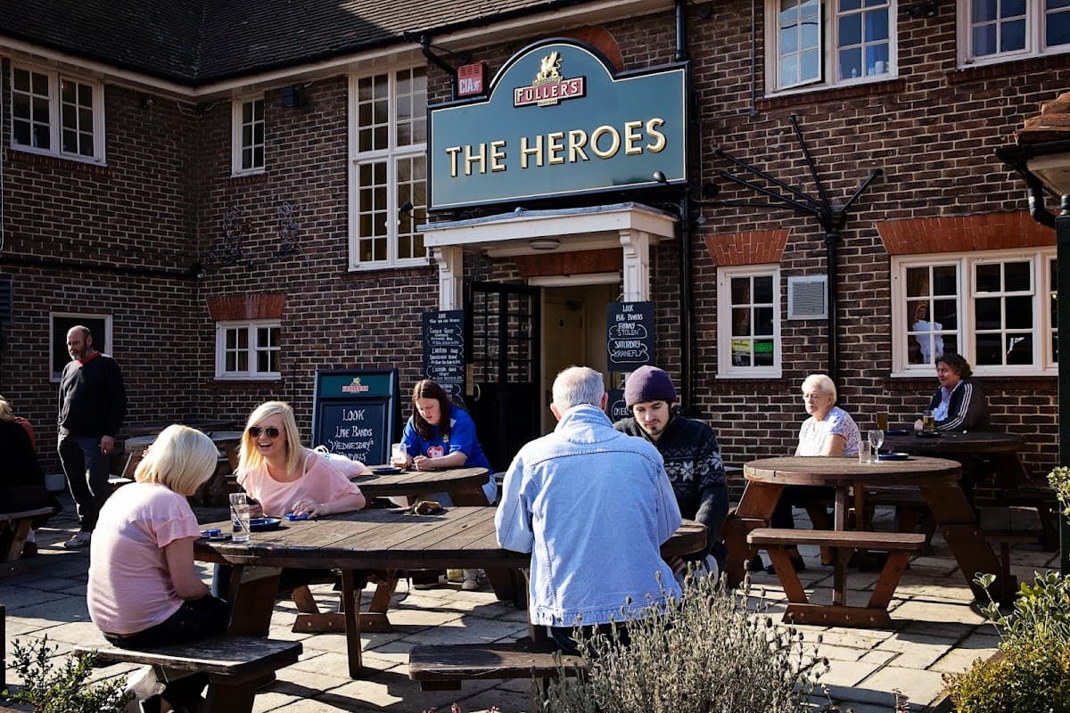 The Heroes pub on London Road, Waterlooville, with drinkers in the garden